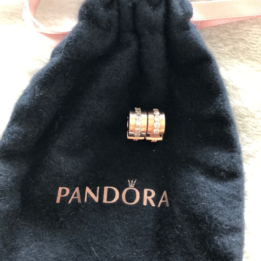 A pair of rose gold pandora clips